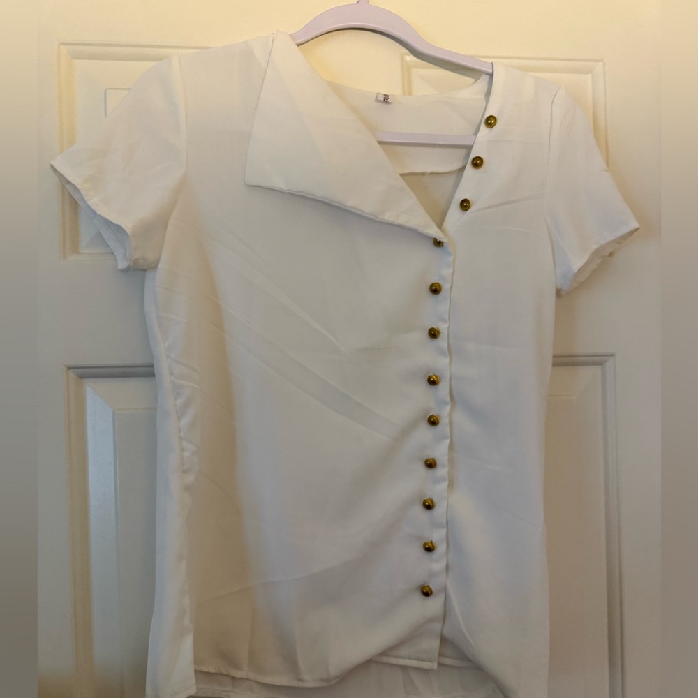 White trendy asymmetrical blouse with gold buttons